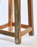 Close up of rustic finish reclaimed wood legs on kitchen stool