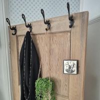 A Row of Swan Cast Iron Hooks on the Top of a Door