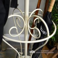 Ornate Scroll Design on the Cream Coat Stand