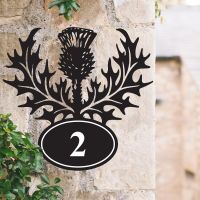 Thistle Iron House Number Sign on a Garden Wall
