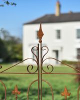 Point At The Top Of The Gothic Style Gate On The Garden Rose Arch