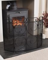 Angled view of ornate triple fold fire guard