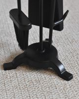 Close up of freestanding base and tools on black fireside companion set