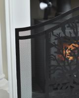 Close up of iron detailing and mesh panelling on decorative black fire guard