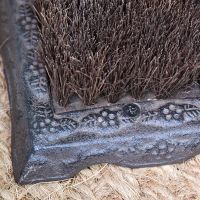 Close up of brush and ornate base surrounding 