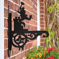 Ornate Chimney Sweep Hanging Basket Bracket Mounted on a Brick wall
