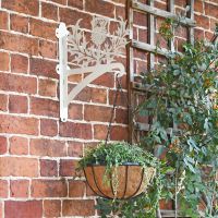 Cream Thistle Design Hanging Basket Bracket Mounted on a Garden Wall