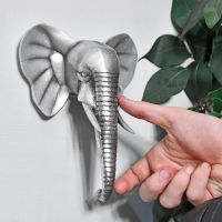 Elephant Wall Art in Silver with hand for scale 