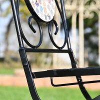 Close up of metal framework on chair with mosaic back 