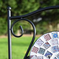 Close up of scroll work and mosaic backrest 