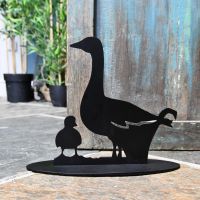 Duck Iron Door Stop Next to a Rustic Blue Door