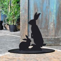 Rabbit Iron Door Stop Next to a Rustic Blue Door