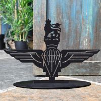 British Parachute Regiment Iron Door Stop Next to a Rustic Blue Door