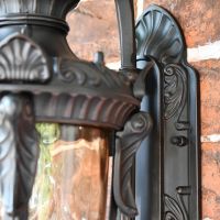 Close up of decorative detailing on lantern and mounting plate 