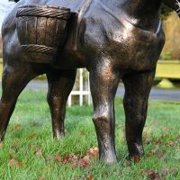 Close up of sculpture"s leg and basket 