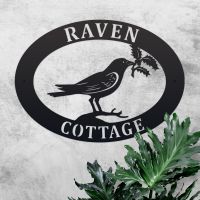 Raven & Holly Iron Oval House Sign in Use Outdoors