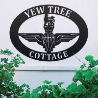 British Parachute Regiment Iron Oval House Sign on a White Wall