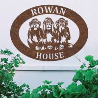 "See No Evil, Hear No Evil, Speak No Evil" Iron Oval House Sign on a White Wall