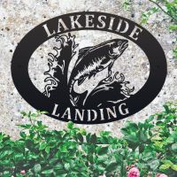Freshwater Salmon Iron Oval House Sign on a Stone Wall