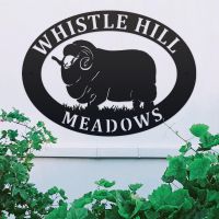 Merino Sheep Iron Oval House Sign on a White Wall