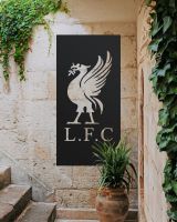 Black "Liver Bird Wall Art" on a cream brick wall next to stone steps