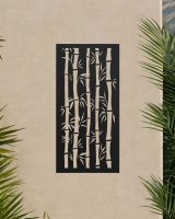 Black "Bamboo Garden Wall Art" on an outdoor wall surrounded by palm leaves 