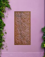 Chic "Rust Finish Zebra print Garden Wall Art" mounted on a purple garden wall 