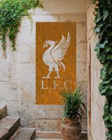 Rustic "Liver Bird Wall Art" on a brick wall next to stone stairs and surrounded by plants