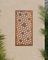 Rustic" Honeycomb Pattern Wall Art" on a beige garden wall surrounded by palm leaves