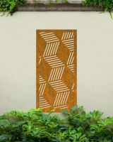 Rustic "Geometric Cube Wall Art" mounted on a cream garden wall surrounded by foliage