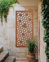Rustic" Honeycomb Pattern Wall Art" on a brick wall next to stone steps
