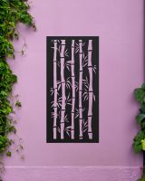 Black "Bamboo Garden Wall Art" mounted onto a purple garden wall amongst garden plants