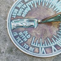 Close-Up of Old Father Time Design on Verdigris Sundial