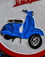 Close up of "Vespa" Cast Iron Automobilia Reproduction Sign finish