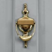 Polished Brass Urn Door Knocker on a Grey Door
