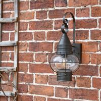 Vintage Round Caged Wall Lantern in Situ on a Brick Wall