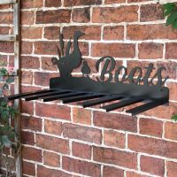 Wall Mounted Duck Iron Boot Holder Mounted on a Brick Wall