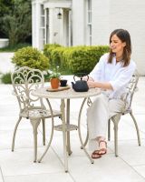 Woman Sat at Champagne Garden Furniture Set 