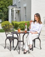Woman Sat at Copper Garden Furniture Set
