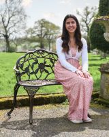 Woman Sat On Bronze Finish Bench 