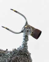 Close up of face detail on recycled metal art sculpture