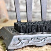 Close up of cast iron base, brush and garden fork 