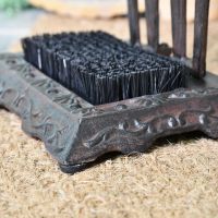Side view of cast iron base with decorative detailing 