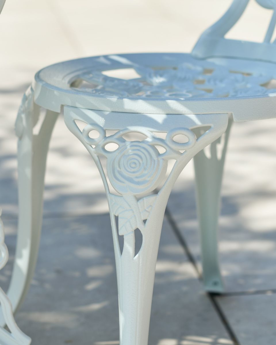 Close up of floral chair leg detail on garden bistro set
