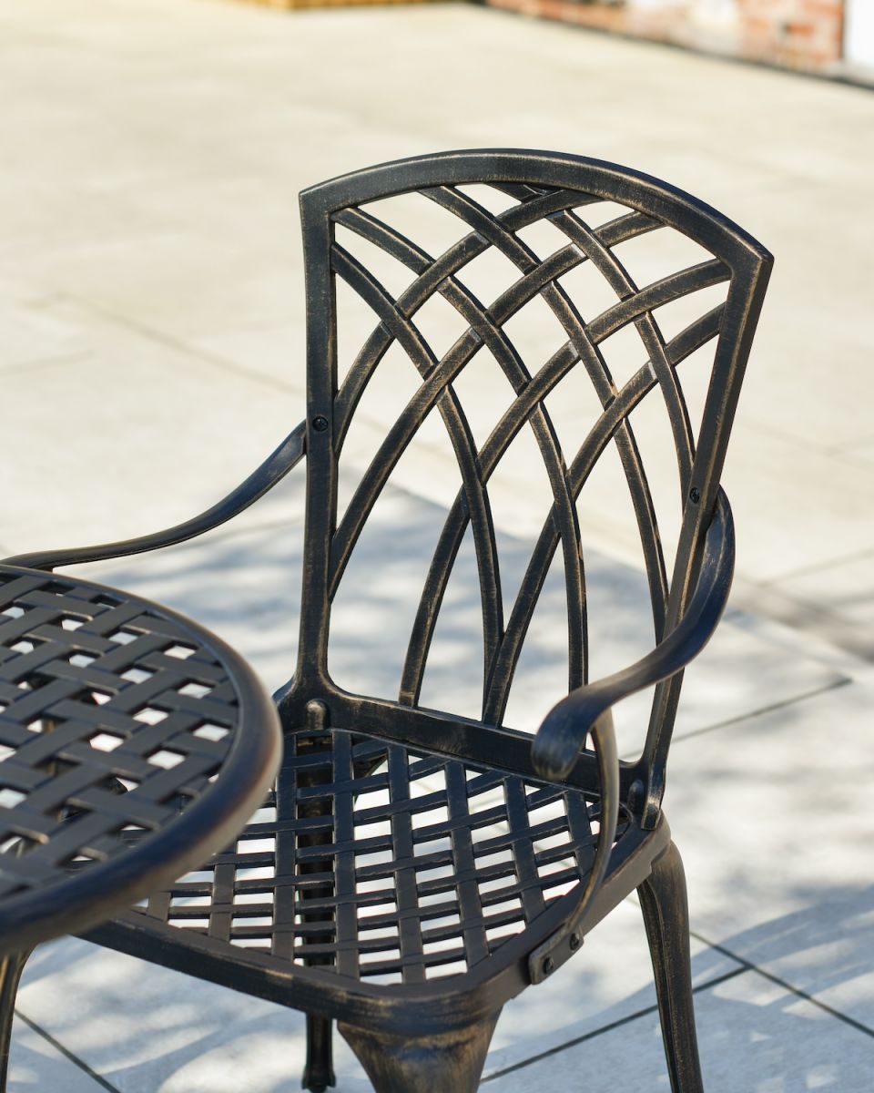 Close up of intricate on chair backrest on garden two seater table and chairs set Close up of intricate on chair backrest on garden two seater table and chairs set