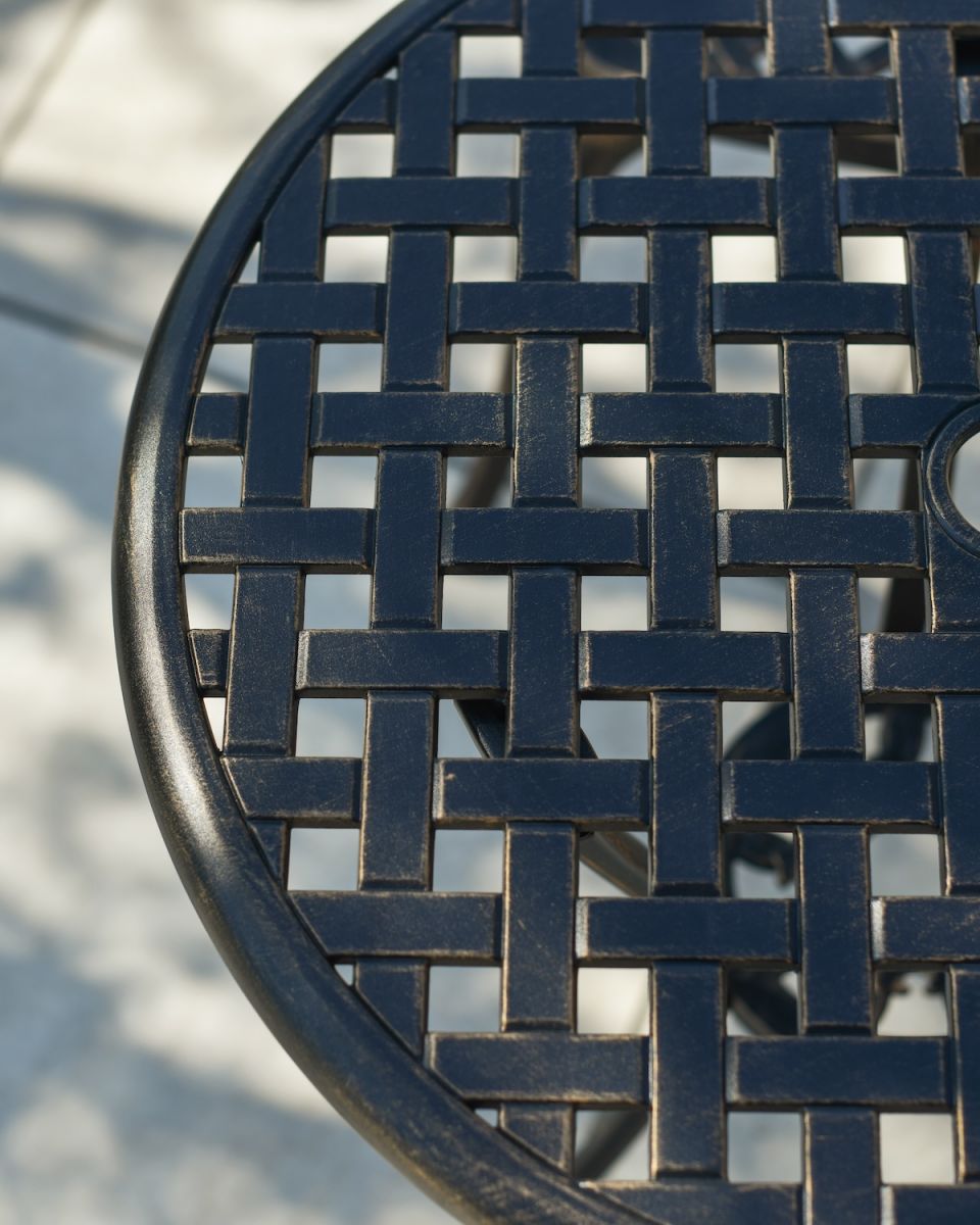 Close up of intricate crosshatch detail on table top of outdoor bistro set Close up of intricate crosshatch detail on table top of outdoor bistro set