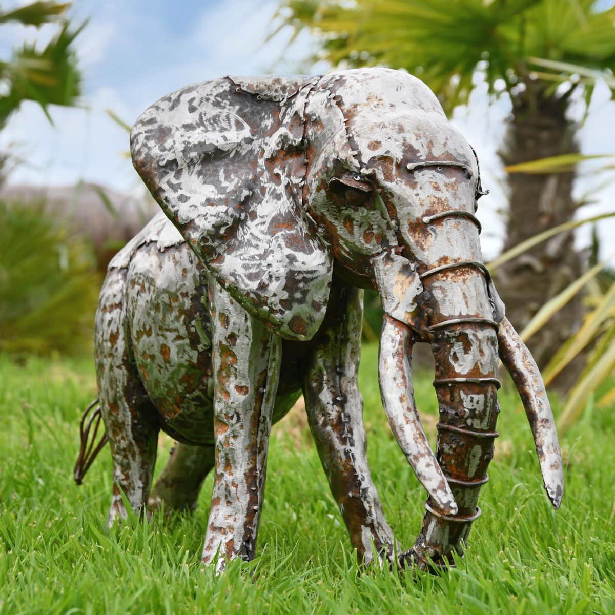 Recycled Metal Elephant with Trunk Up in Situ in the Garden