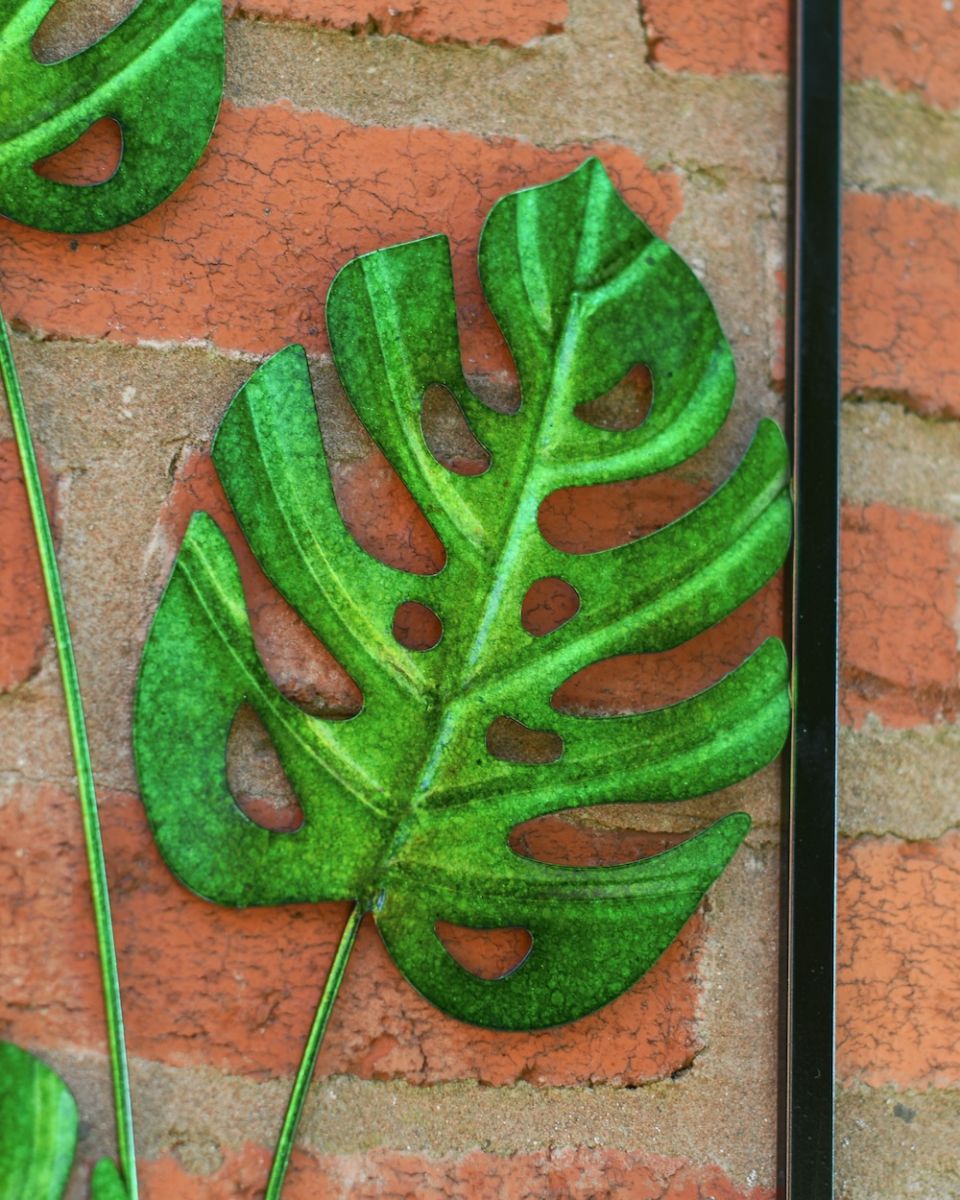 Close up of intricate steel leaf detail on garden wall art