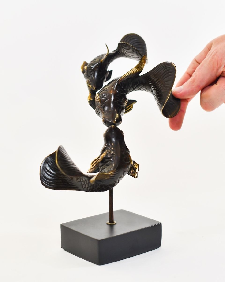 "Duelling Currents" Koi Ornament in Cast Brass with hand in shot for scale