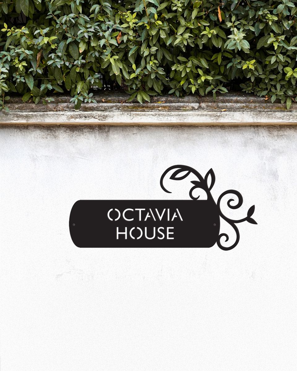 "Lovestone" Steel House Name Sign Mounted onto a White Garden Wall "Lovestone" Steel House Name Sign Mounted onto a White Garden Wall